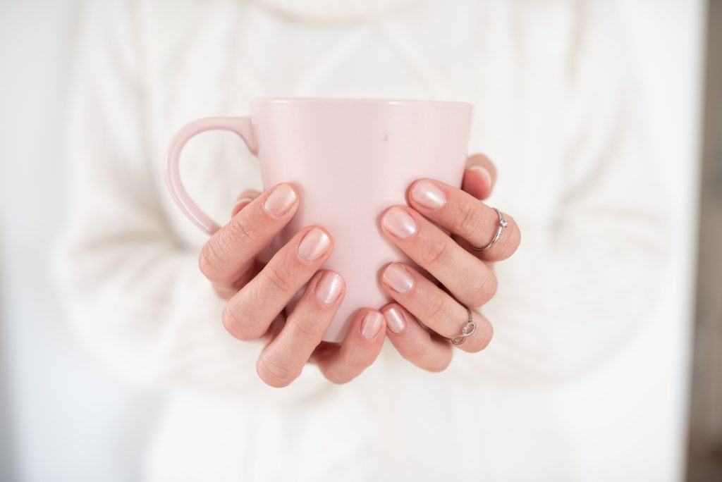 Cozy lifestyle stock photo of a woman holding a coffee mug from Styled Stock